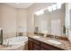 Bathroom boasts double sinks, granite countertops, and a large mirror at 20716 Amanda Oak Ct, Land O Lakes, FL 34638
