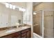 Bathroom with double vanity, granite countertops, and a large shower at 20716 Amanda Oak Ct, Land O Lakes, FL 34638