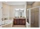 Elegant bathroom with double vanity, soaking tub, and walk-in shower at 20716 Amanda Oak Ct, Land O Lakes, FL 34638