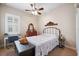 Charming bedroom with antique dresser, ceiling fan and window shutters at 20716 Amanda Oak Ct, Land O Lakes, FL 34638