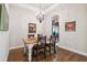 Bright dining room with a rustic farmhouse table and chandelier at 20716 Amanda Oak Ct, Land O Lakes, FL 34638