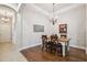 Bright dining room with a rustic farmhouse table and chandelier at 20716 Amanda Oak Ct, Land O Lakes, FL 34638