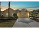 Tan two-car garage home with landscaping and palm trees at 20716 Amanda Oak Ct, Land O Lakes, FL 34638