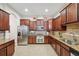 Modern kitchen with granite countertops and stainless steel appliances at 20716 Amanda Oak Ct, Land O Lakes, FL 34638