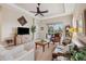 Living room with a leather couch, large TV, and sliding doors at 20716 Amanda Oak Ct, Land O Lakes, FL 34638