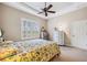 Main bedroom with large window, ceiling fan and plenty of space for furniture at 20716 Amanda Oak Ct, Land O Lakes, FL 34638
