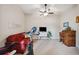 Home office features a comfortable couch, exercise bike, and antique desk at 20716 Amanda Oak Ct, Land O Lakes, FL 34638