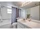 Clean bathroom with a shower/tub combo, vanity, and tiled walls at 2292 Austrian Ln # 22, Clearwater, FL 33763