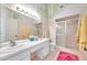 Bathroom with double vanity, shower, and decorative walls at 2292 Austrian Ln # 22, Clearwater, FL 33763