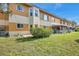 Back of the building, showcasing the patios and green space at 2292 Austrian Ln # 22, Clearwater, FL 33763