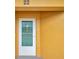 White front door with a window and screen, located on a yellow building at 2292 Austrian Ln # 22, Clearwater, FL 33763