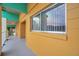 Interior hallway with yellow walls, teal accents, and an exit sign visible at 2292 Austrian Ln # 22, Clearwater, FL 33763