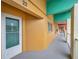 Interior hallway with yellow walls, teal accents, and a view of a door at 2292 Austrian Ln # 22, Clearwater, FL 33763