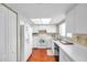 Kitchen features white appliances and wood flooring at 2292 Austrian Ln # 22, Clearwater, FL 33763