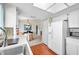 Kitchen features white appliances and wood floors at 2292 Austrian Ln # 22, Clearwater, FL 33763