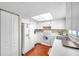 Bright eat-in kitchen, white cabinetry, and wood flooring at 2292 Austrian Ln # 22, Clearwater, FL 33763
