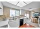 Kitchen with dining area, white cabinets, and wood floors at 2292 Austrian Ln # 22, Clearwater, FL 33763