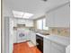 Efficient kitchen with white cabinets and wood flooring at 2292 Austrian Ln # 22, Clearwater, FL 33763