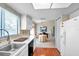 Kitchen with dining area, white cabinets, and hardwood floors at 2292 Austrian Ln # 22, Clearwater, FL 33763