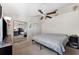 Bright bedroom featuring mirrored closet doors and ceiling fan at 2354 Tallyho Ln, Palm Harbor, FL 34683