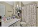 Bathroom with shower/tub combo, vanity with sink, and storage at 30618 Birdhouse Dr, Wesley Chapel, FL 33545