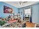 bedroom with twin-size bed, desk, and playful decor at 30618 Birdhouse Dr, Wesley Chapel, FL 33545