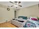 Bedroom with king-size bed, ceiling fan, and access to a patio at 30618 Birdhouse Dr, Wesley Chapel, FL 33545