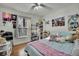 Bedroom with a full-size bed, ample storage, and fun decor at 30618 Birdhouse Dr, Wesley Chapel, FL 33545