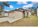 Exterior view of house and yard at 30618 Birdhouse Dr, Wesley Chapel, FL 33545