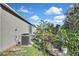 View of house side, AC unit, and landscaping at 30618 Birdhouse Dr, Wesley Chapel, FL 33545