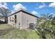 View of house side, AC unit, and landscaping at 30618 Birdhouse Dr, Wesley Chapel, FL 33545
