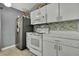 Kitchen with white cabinets, and a modern electric range at 30618 Birdhouse Dr, Wesley Chapel, FL 33545