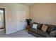 Bedroom with couch, double doors, and access to bathroom at 4221 W Spruce St # 1212, Tampa, FL 33607