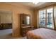 Bedroom with a dresser, large window, and view into the living room at 4221 W Spruce St # 1212, Tampa, FL 33607