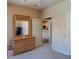 Bedroom with dresser, view of kitchen, and neutral walls at 4221 W Spruce St # 1212, Tampa, FL 33607