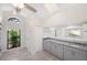 Elegant bathroom with gray cabinets, granite countertops, and a large window at 520 Centerbrook Dr, Brandon, FL 33511