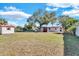 Spacious backyard offering a large grassy area and shed at 5711 S Coolidge Ave, Tampa, FL 33616