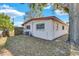 Backyard view of the home showcasing a large yard and storage shed at 5711 S Coolidge Ave, Tampa, FL 33616