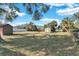 Large backyard with two storage sheds and mature trees at 5711 S Coolidge Ave, Tampa, FL 33616