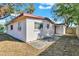 Backyard view of home with patio and additional storage shed at 5711 S Coolidge Ave, Tampa, FL 33616