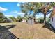 Backyard view of home with storage shed and clothesline at 5711 S Coolidge Ave, Tampa, FL 33616