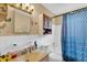 Clean bathroom with shower/tub combo and blue patterned curtain at 5711 S Coolidge Ave, Tampa, FL 33616