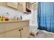 Clean bathroom with shower/tub combo and blue patterned curtain at 5711 S Coolidge Ave, Tampa, FL 33616