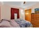 Bright bedroom with double bed and wood dresser at 5711 S Coolidge Ave, Tampa, FL 33616