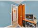 Bedroom with small tv stand and access to hallway at 5711 S Coolidge Ave, Tampa, FL 33616