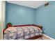 Small bedroom with twin bed and blue walls at 5711 S Coolidge Ave, Tampa, FL 33616