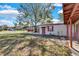 House with carport, yard, and red door at 5711 S Coolidge Ave, Tampa, FL 33616