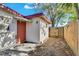 Back exterior of house with access door and walkway at 5711 S Coolidge Ave, Tampa, FL 33616