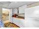 Galley kitchen with white cabinets and appliances at 5711 S Coolidge Ave, Tampa, FL 33616