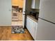 White kitchen cabinets, appliances, and a decorative rug at 5711 S Coolidge Ave, Tampa, FL 33616